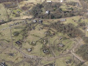 Oblique aerial view centred on the central section of the explosives factory with Dargavel House adjacent, taken from the