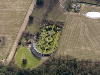 Oblique aerial view centred on the walled garden and estate cottage, taken from the NNW.