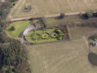 Oblique aerial view centred on the walled garden and estate cottage, taken from the W.