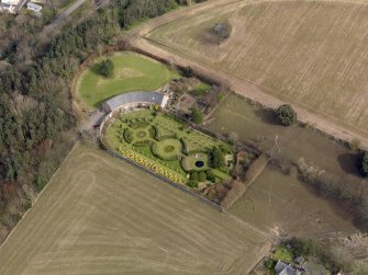 Oblique aerial view centred on the walled garden and estate cottage, taken from the SW.