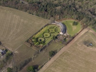 Oblique aerial view centred on the walled garden and estate cottage, taken from the SE.