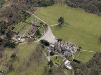 Oblique aerial view centred on the house with the walled garden adjacent, taken from the NW.