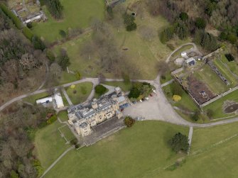 Oblique aerial view centred on the house with the walled garden adjacent, taken from the SW.