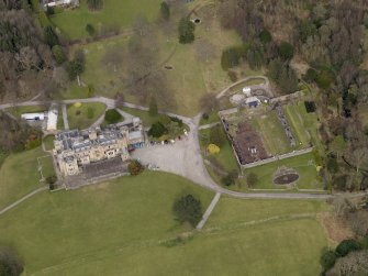 Oblique aerial view centred on the house with the walled garden adjacent, taken from the SSW.