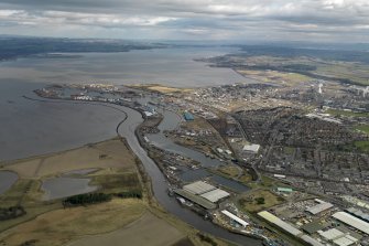 General oblique aerial view centred on the town and docks, taken from the SW.