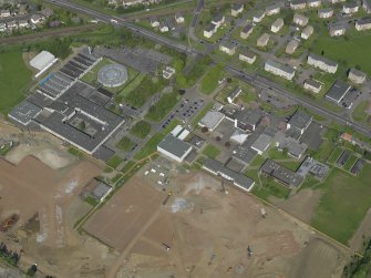 Oblique aerial view centred on St Augustine's High and Forrester Secondary Schools, taken from the SW.