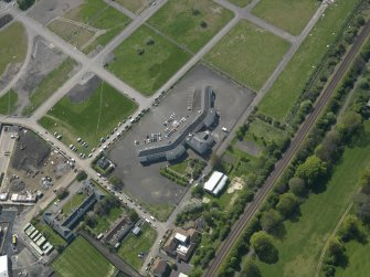 Oblique aerial view centred on Craigmiller Primary School, taken from the NE.