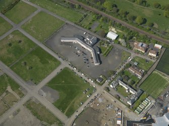 Oblique aerial view centred on Craigmiller Primary School, taken from the SE.