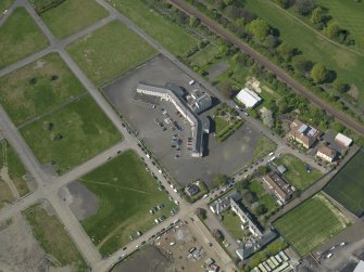 Oblique aerial view centred on Craigmiller Primary School, taken from the SE.