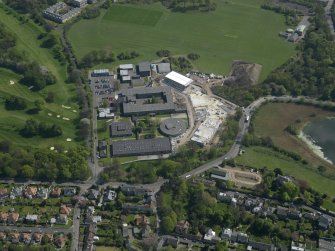 Oblique aerial view centred on the school, taken from the NW.