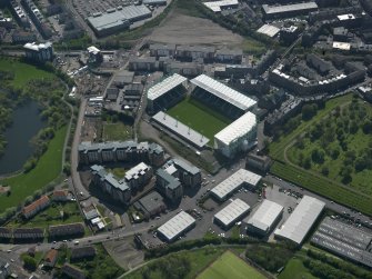 Oblique aerial view centred on the football stadium, taken from the NNE.