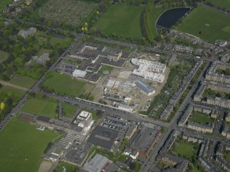 Oblique aerial view centred on the school with the Police Headquarters adjacent, taken from the SW.