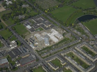 Oblique aerial view centred on the school with the Police Headquarters adjacent, taken from the SW.