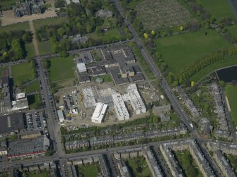 Oblique aerial view centred on the school with the Police Headquarters adjacent, taken from the E.