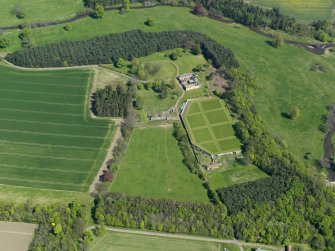 Oblique aerial view centred on the walled garden with the stable block adjacent, taken from the SW.