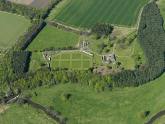 Oblique aerial view centred on the walled garden with the stable block adjacent, taken from the SSE.