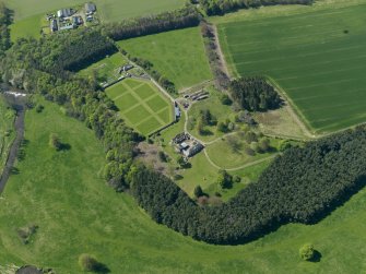 Oblique aerial view centred on the walled garden with the stable block adjacent, taken from the E.