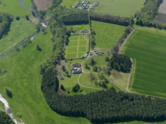 Oblique aerial view centred on the walled garden with the stable block adjacent, taken from the NE.