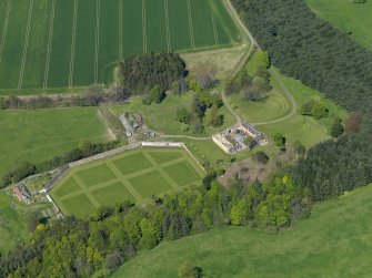 Oblique aerial view centred on the walled garden with the stable block adjacent, taken from the SE.