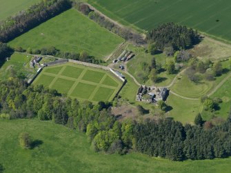 Oblique aerial view centred on the walled garden with the stable block adjacent, taken from the SE.