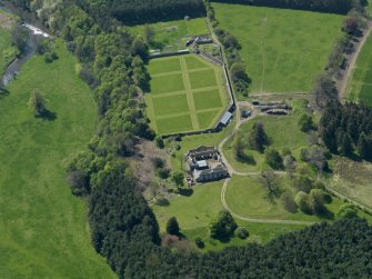 Oblique aerial view centred on the walled garden with the stable block adjacent, taken from the NE.