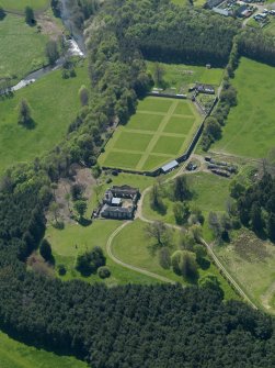 Oblique aerial view centred on the walled garden with the stable block adjacent, taken from the NNE.