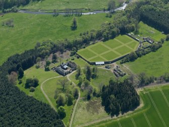 Oblique aerial view centred on the walled garden with the stable block adjacent, taken from the N.