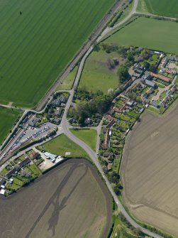 Oblique aerial view centred on the village with the railway station adjacent, taken from the NE.