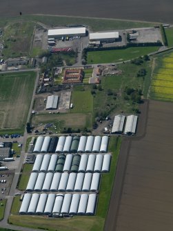 Oblique aerial view centred on the technical area with the aircraft hangars adjacent, taken from the ENE.