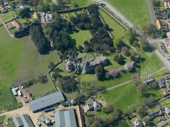 Oblique aerial view centred on the castle with the garden adjacent, taken from the E.