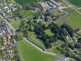 Oblique aerial view centred on the castle with the garden adjacent, taken from the WNW.