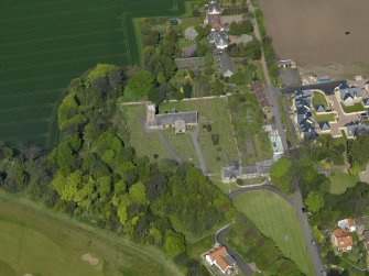 Oblique aerial view centred on the parish church with the church hall adjacent, taken from the S.