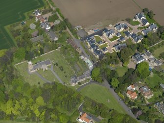 Oblique aerial view centred on the parish church with the church hall adjacent, taken from the SW.
