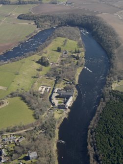 General oblique aerial view looking along the River Tay centred on the former mill following redevelopment into a visitor centre and flats with the country house beyond, taken from the W.