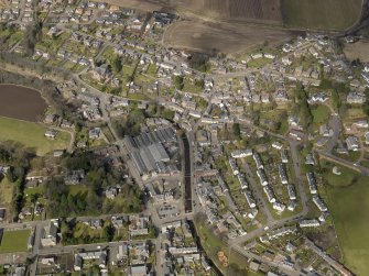 General oblique aerial view of the town centred on the carpet mill, taken from the SSE.