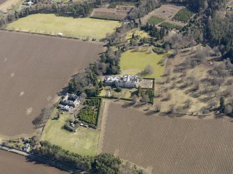 Oblique aerial view centred on the country house and stables, taken from the NW.