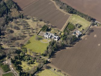 Oblique aerial view centred on the country house and stables, taken from the ESE.