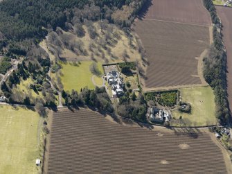 Oblique aerial view centred on the country house and stables, taken from the NNE.
