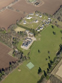 Oblique aerial view centred on the country house, its policies and the modern housing development, taken from the SSW.