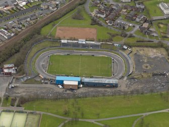 Oblique aerial view centred on the football ground, taken from the NNW.