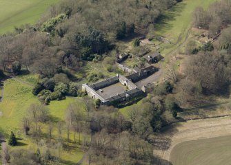 Oblique aerial view centred on the stable block, taken from the E.