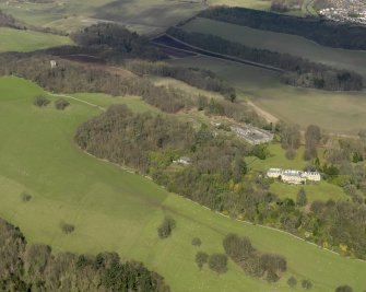General oblique aerial view centred on the house with the stable block adjacent, taken from the SSE.
