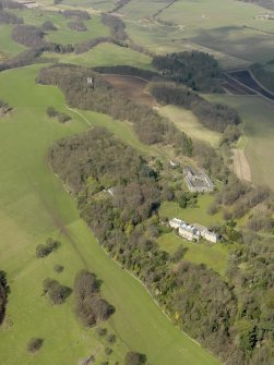 General oblique aerial view centred on the house with the stable block adjacent, taken from the ESE.