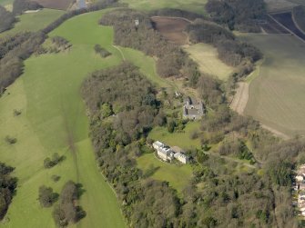 General oblique aerial view centred on the house with the stable block adjacent, taken from the E.