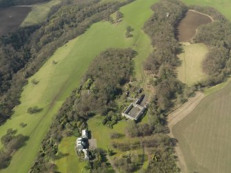 General oblique aerial view centred on the house with the stable block adjacent, taken from the ENE.