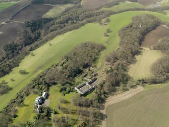 General oblique aerial view centred on the house with the stable block adjacent, taken from the NE.
