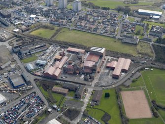 Oblique aerial view centred on the Nairn's North linoleum works with the steel works adjacent, taken from the NNW.