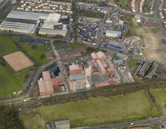 Oblique aerial view centred on the Nairn's North linoleum works with the steel works adjacent, taken from the S.