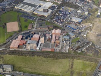 Oblique aerial view centred on the Nairn's North linoleum works with the steel works adjacent, taken from the SE.