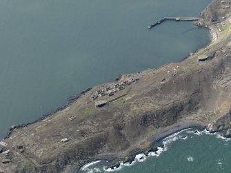 Oblique aerial view centred on part of S defences, taken from the SE.